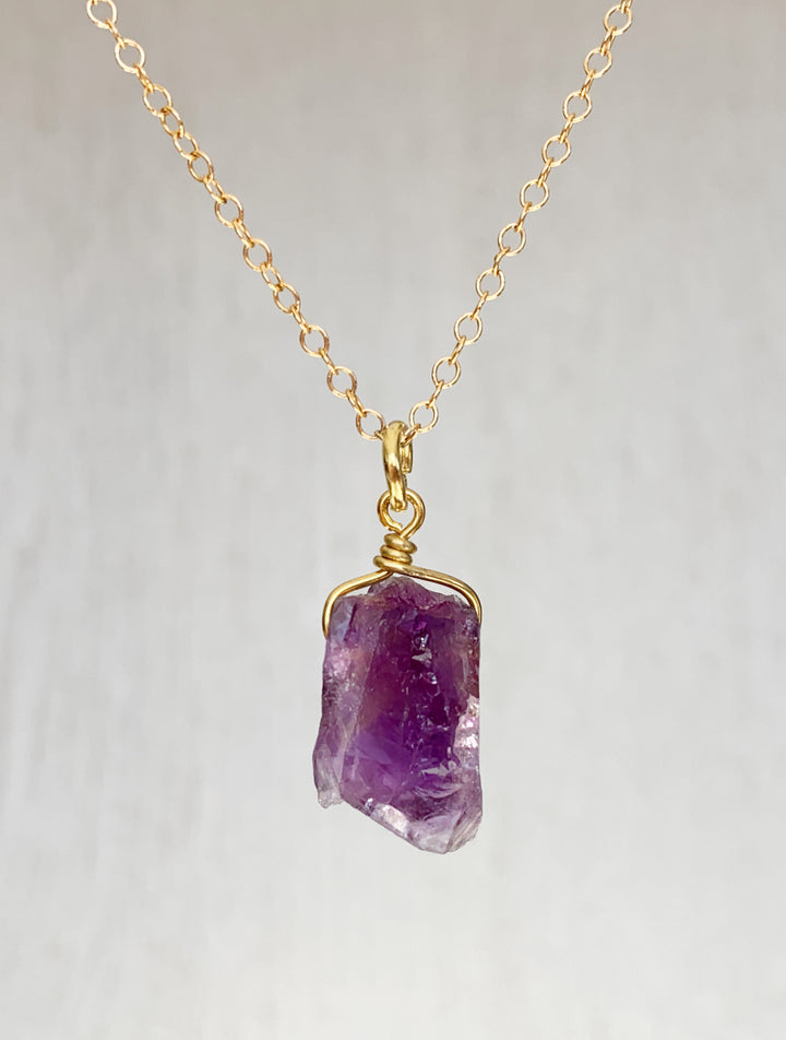 Raw amethyst necklace on gold chain, Natural amethyst gemstone necklace, Handmade raw amethyst pendant, Unpolished amethyst crystal jewelry, Raw amethyst pendant, Amethyst healing crystal necklace, Purple amethyst necklace, Minimalist raw amethyst charm, Boho raw amethyst gemstone jewelry, Genuine amethyst necklace gift, Amethyst pendant with gold chain, Ethereal purple gemstone necklace, Amethyst Rough Pendant Gold Necklace, Raw Amethyst Necklace, February Birthstone, Peace Stone.